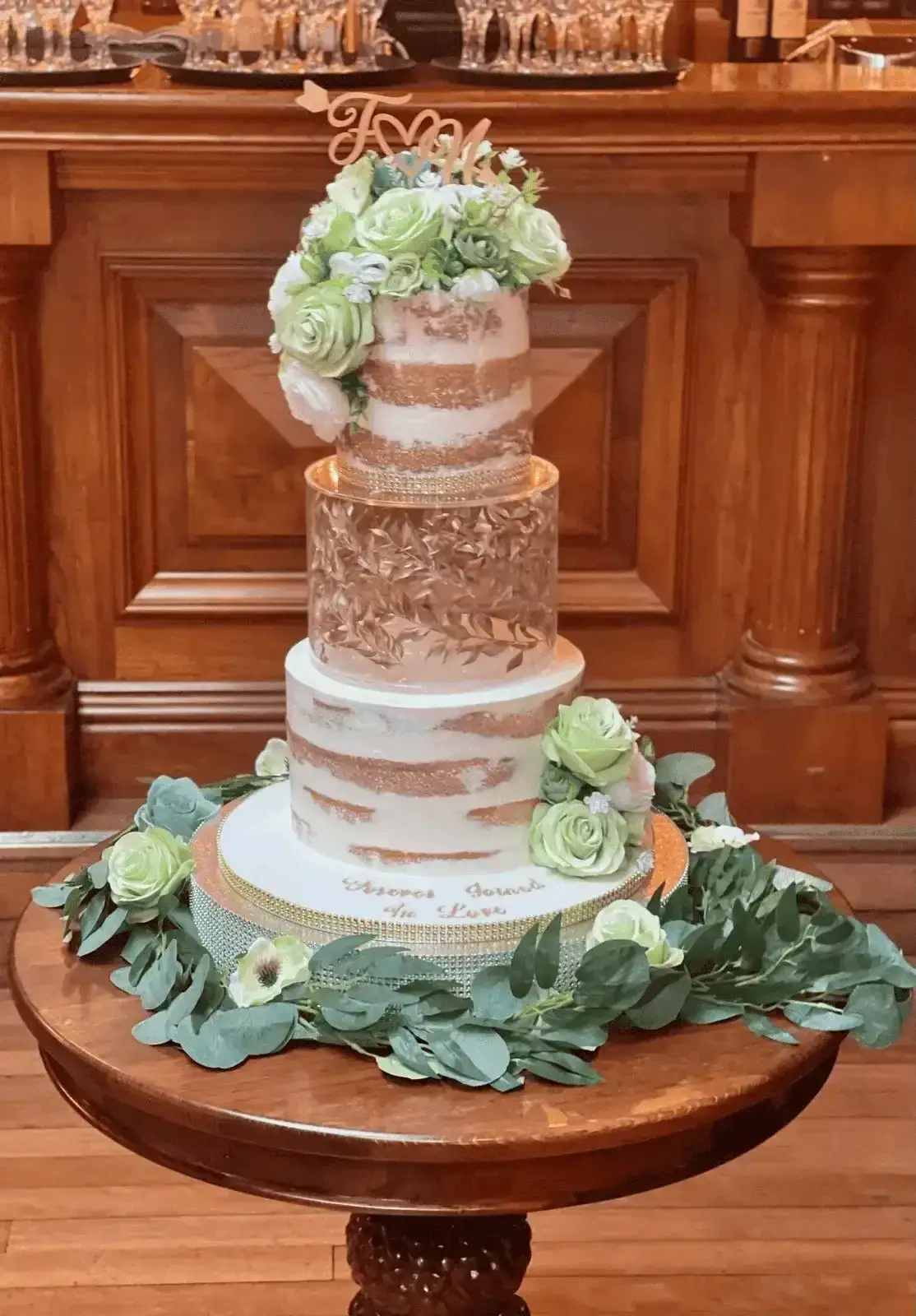 Naked tier wedding cake with rose-gold accents