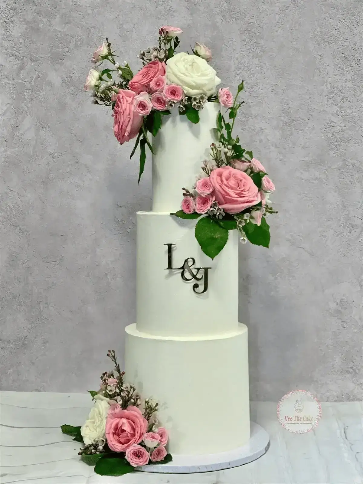 Minimal white wedding cake with fresh pink and cream flowers