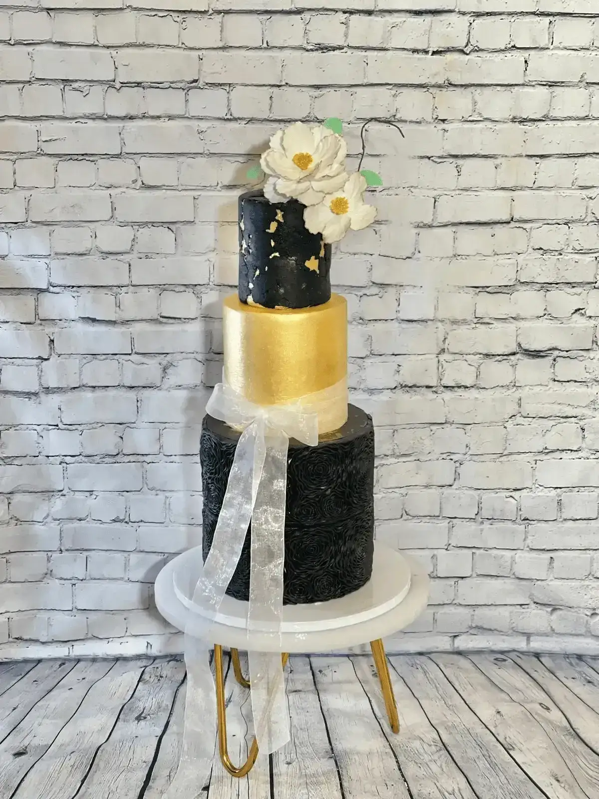Black and gold three-tier wedding cake