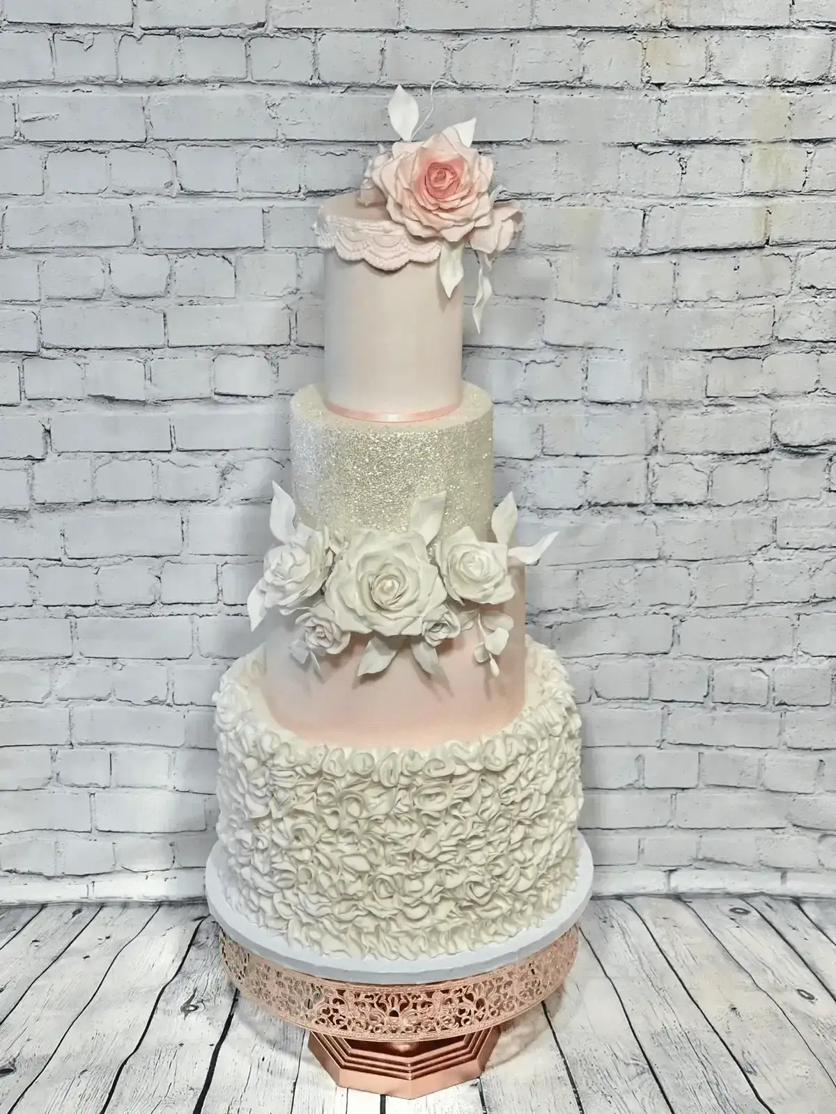 Tall blush and ivory wedding cake with floral detailing