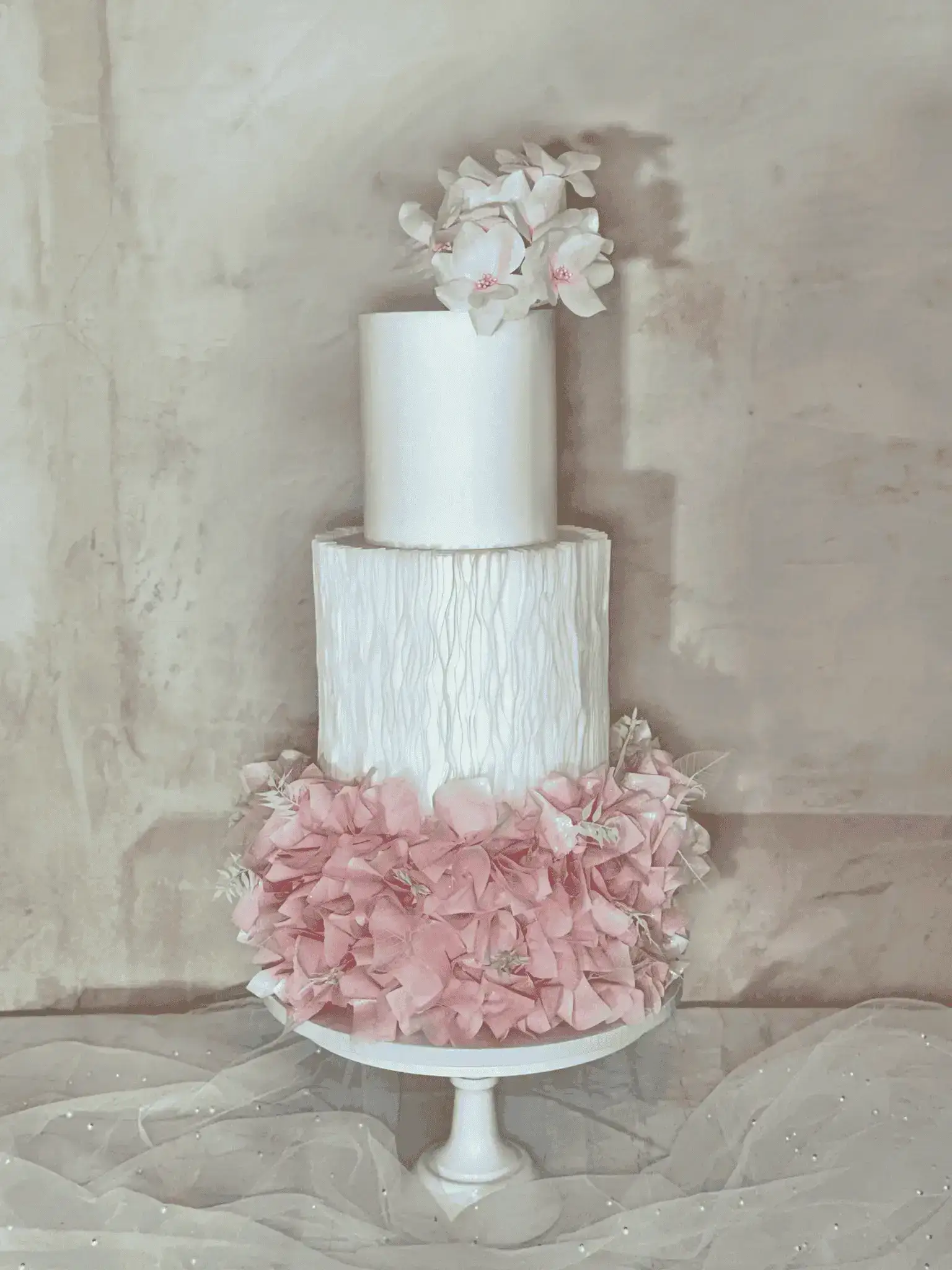 Three-tier floral wedding cake with initials